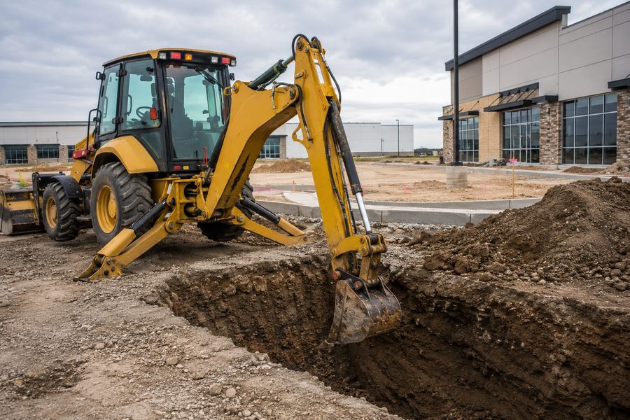 Commercial trench excavation for drainage and utilities on a Colorado job site